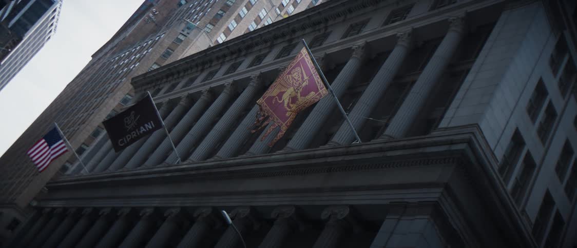 Exterior view of a building with three flags