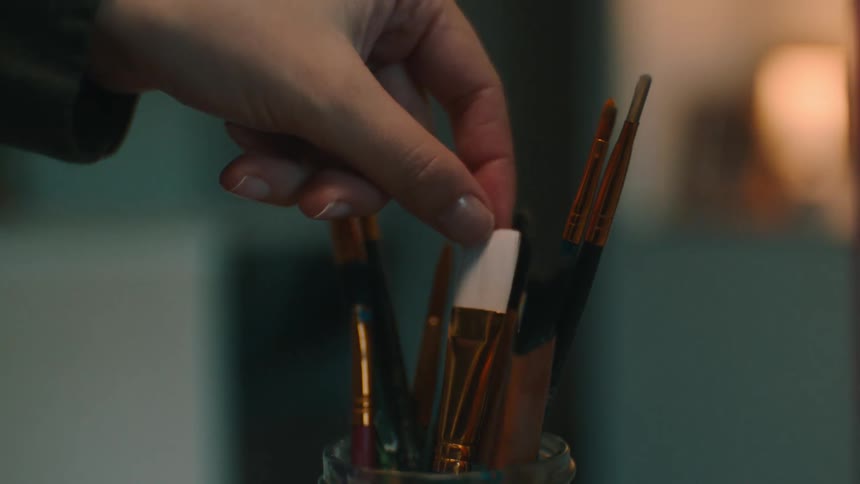 A clip of a hand selecting painting brushes