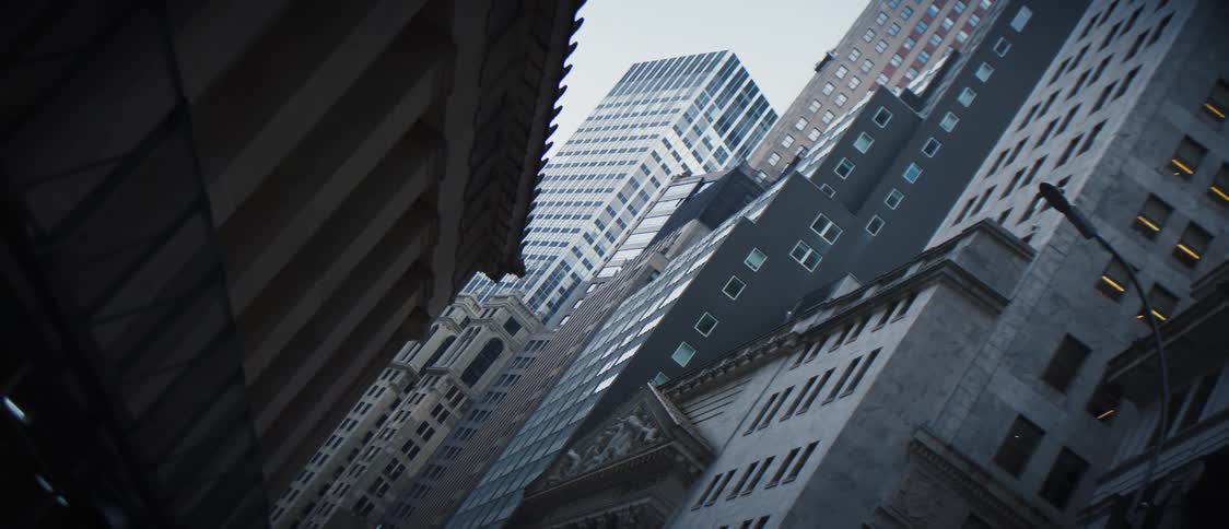 A narrow city street coming from a tower block