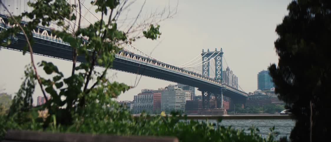A boat passes by on a river near a city