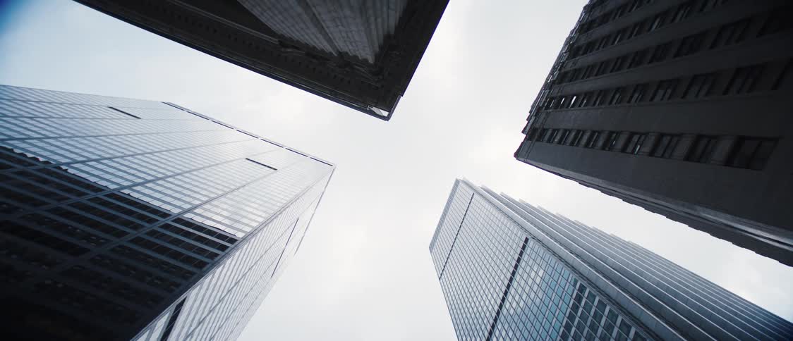 Heavy clouds hang over the tall buildings