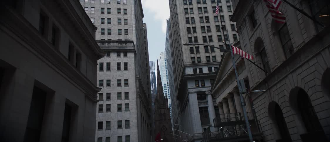 Panorama of a street and a half in a metropolis with large commercial and business buildings and a church in the background