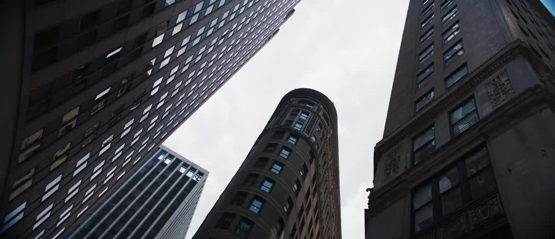Upward view of buildings on a day with sky with clouds