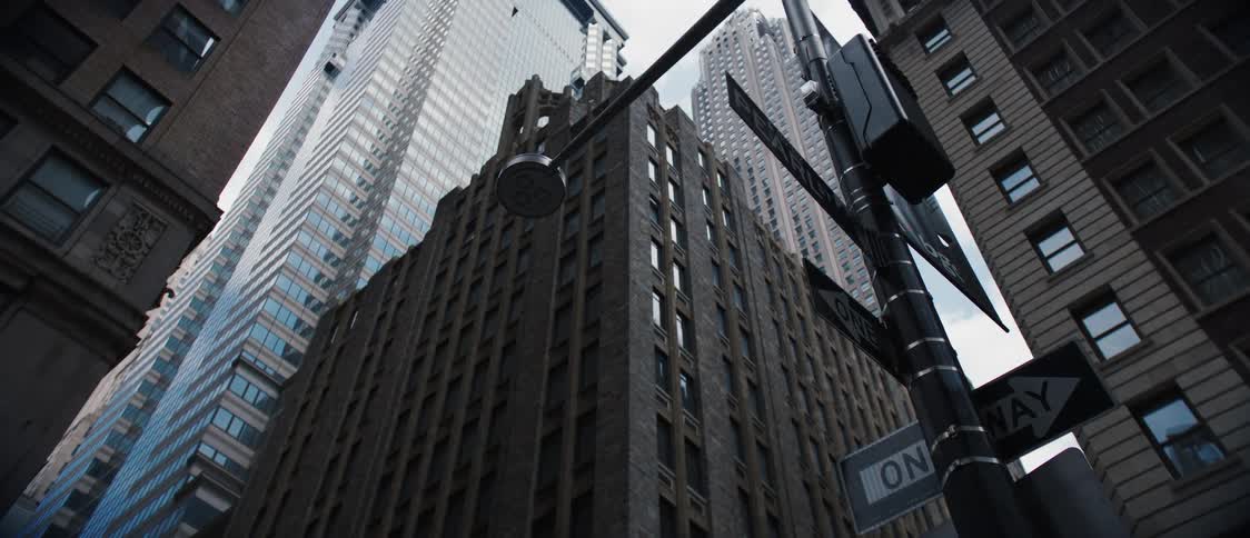Looking up at a group of skyscrapers in an urban area on a partly cloudy day
