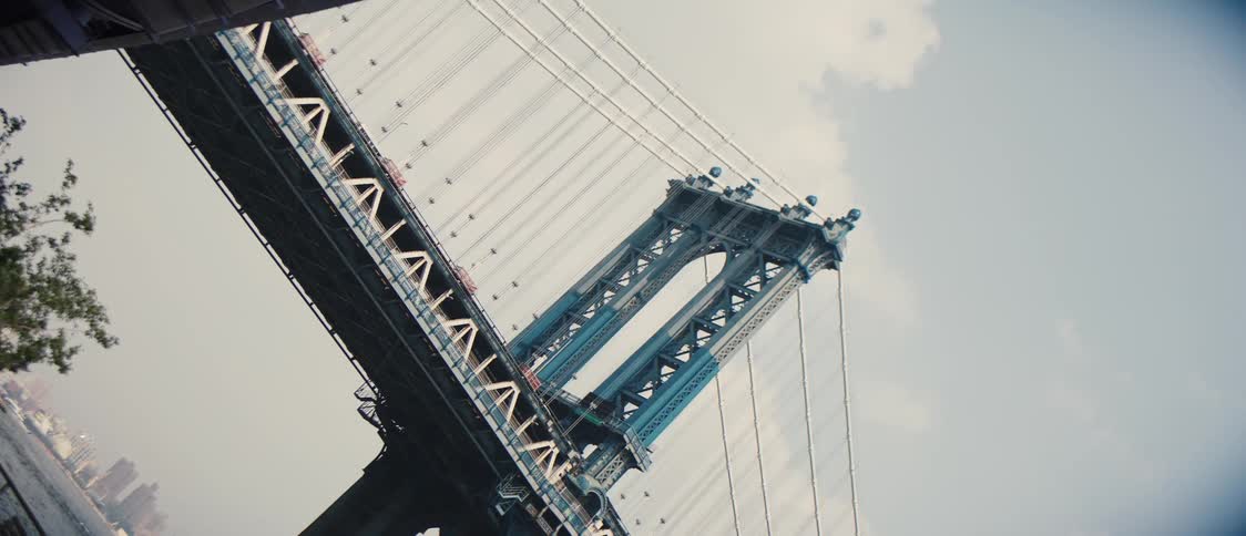 View of a blue bridge suspended in a metropolis