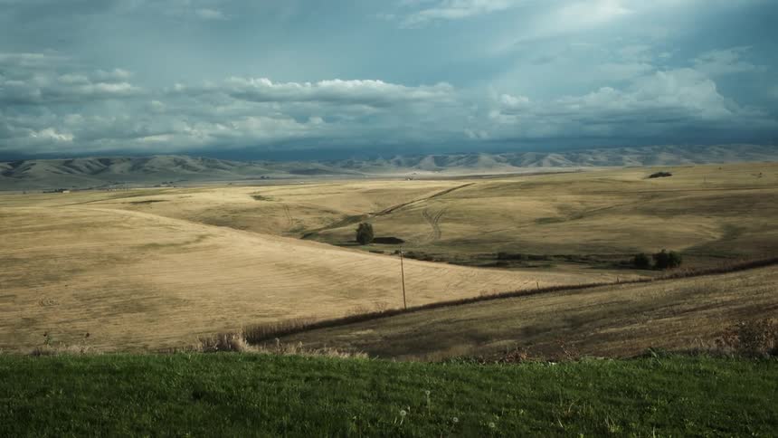 Landscape of a plain field with hills on the background outdoors during day time