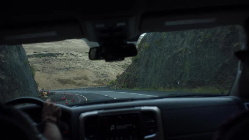 A person is riding on the mountain road