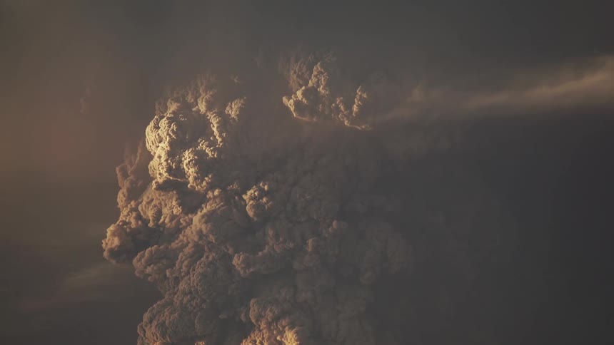 An enormous volcanic eruption throws ash clouds high into the air