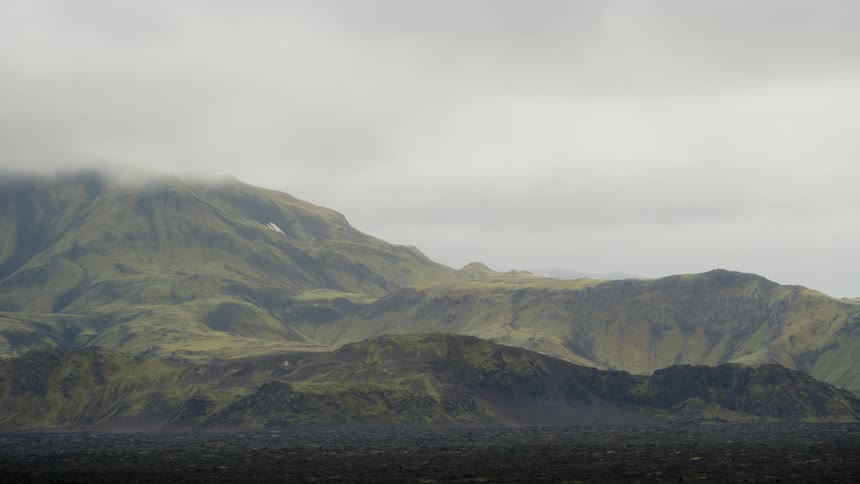 Panorama of mountain ranges with clouds passing by and sawmill in timelapse