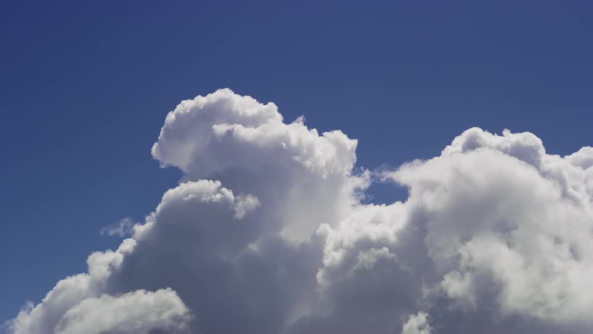 Blue sky with moving clouds in timelapse