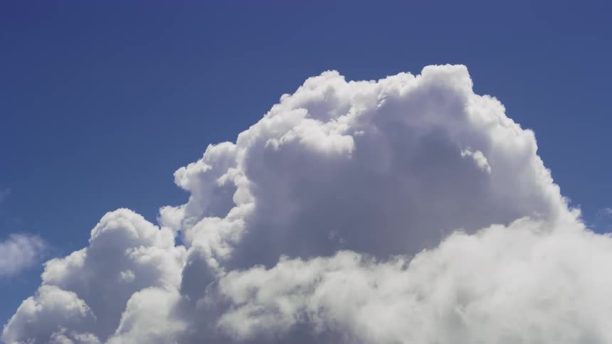 View of clouds passing under a blue sky