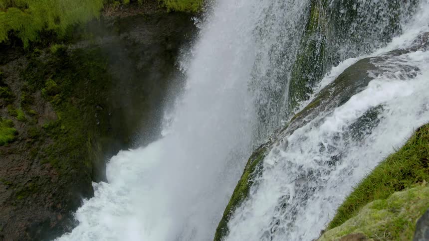 Aerial of a mountain waterfall with moss
