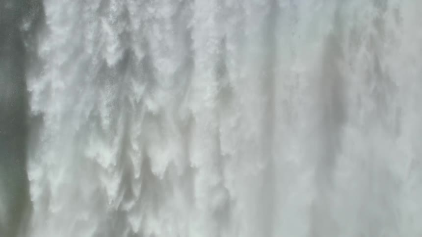 Freefalling waterfall with a rainbow in slow motion