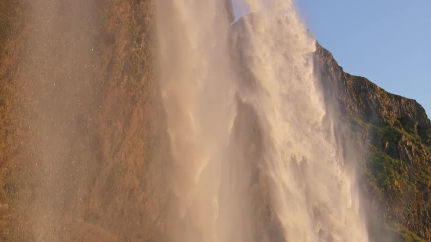 Water cascading from a waterfall freely in slow motion