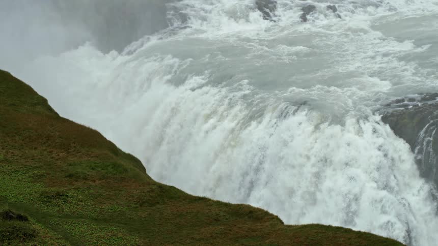 Panorama of freefalling flowing water in a waterfall