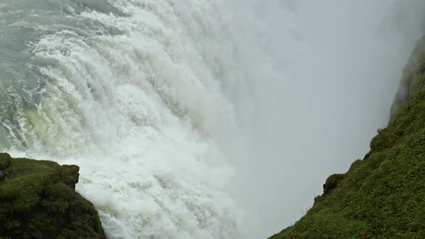 An enormous waterfall next to a mountain
