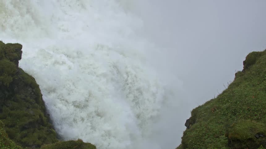 Whitewater waterfall spills between rocky crevice