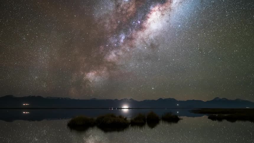 The lake reflects the starry sky at night