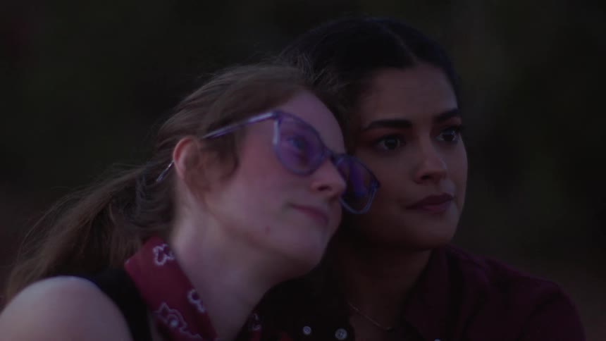 Portrait of two women with their faces leaning against each other