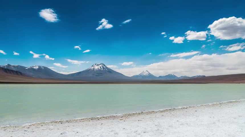 A beach and lake near a mountain range