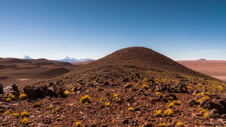 Panorama of hills and plateaus in a desertlike environment with a blue sky