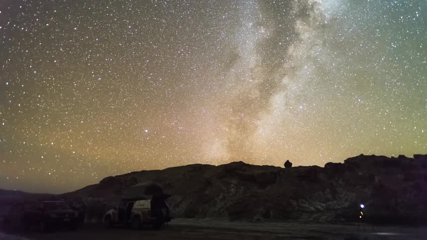 A group of people assemble to photograph or film the milky way