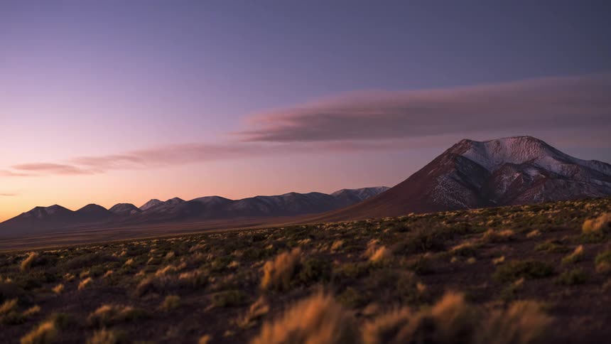 A region with some mountains and time is passing and the starry night appears