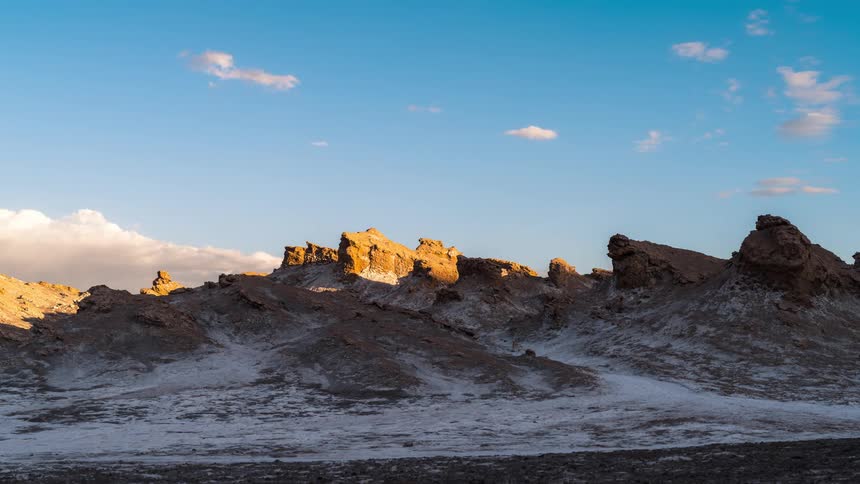A mountain range with snow melting in the desert as the hours pass