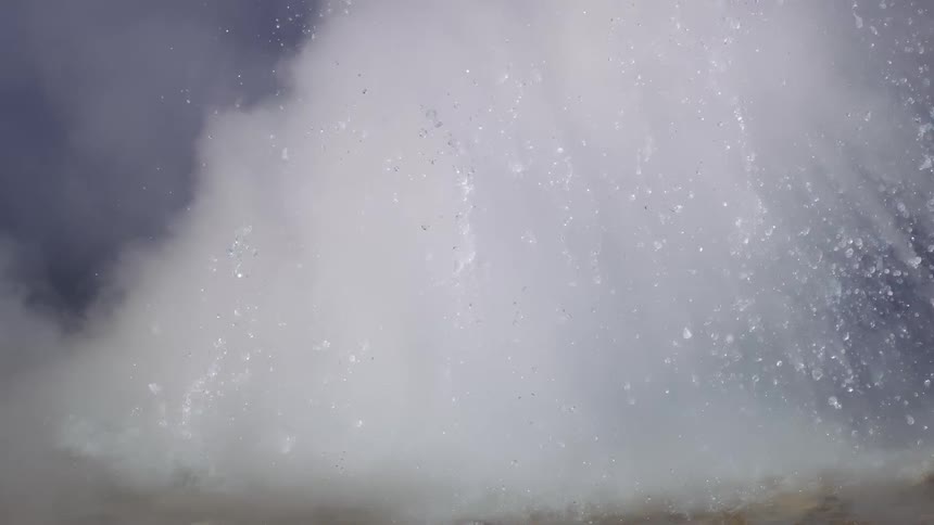 Natural cave splashing hot water with slow motion steam