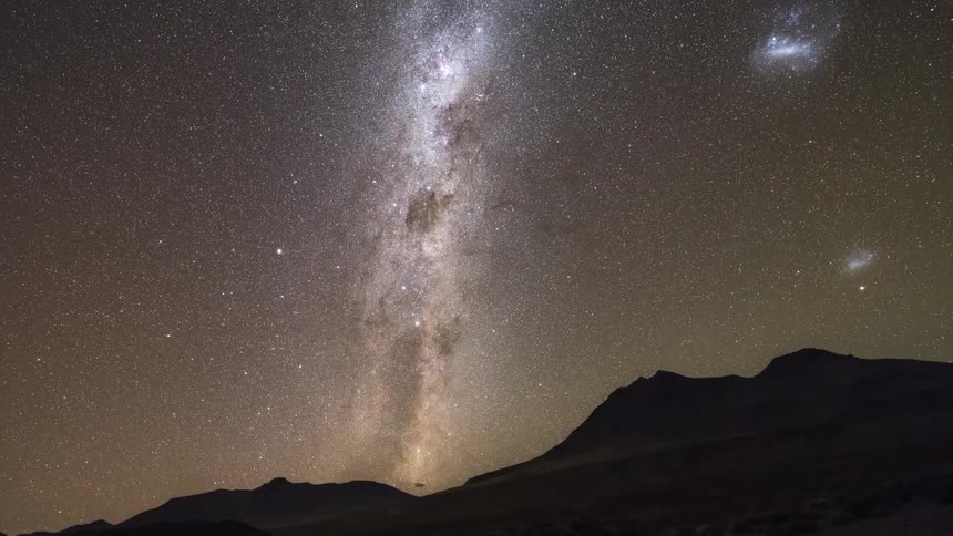 A nebula in the starry desert sky lit up the night
