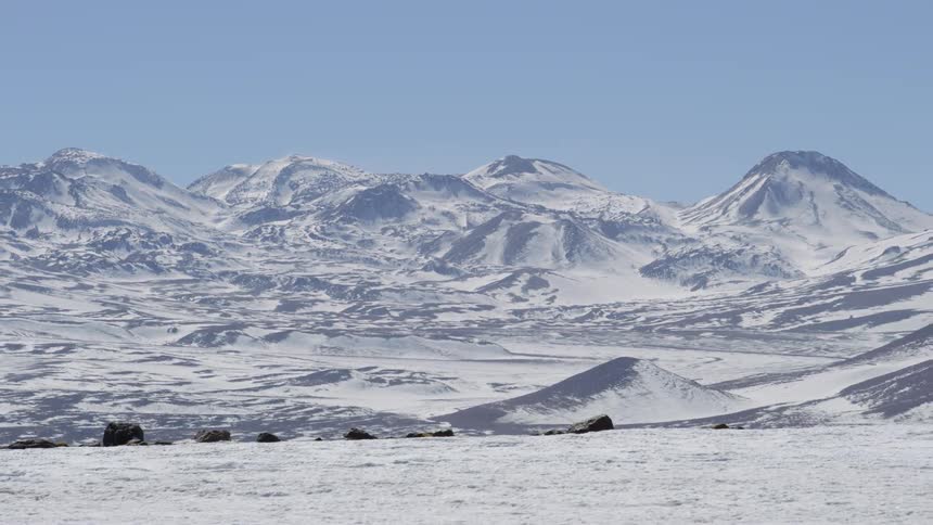 Mountain range and peaks covered in snow on a cloudless day
