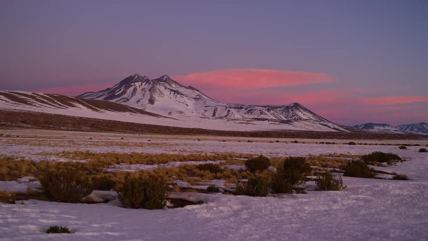 Snow covered mountains with purple dawn sky