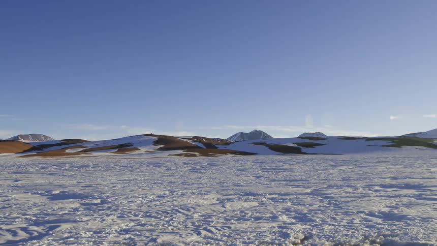 Snow lies deep on hills and the surrounding area