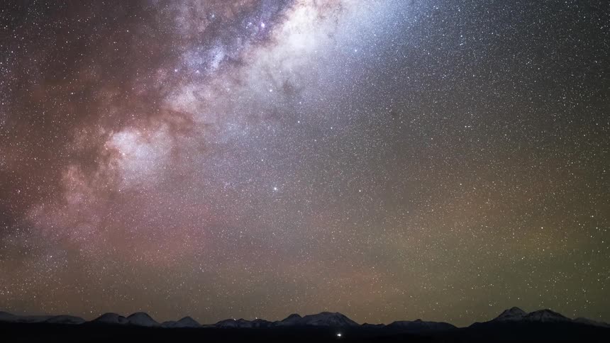 A view of the sky next to mountains and its all starry