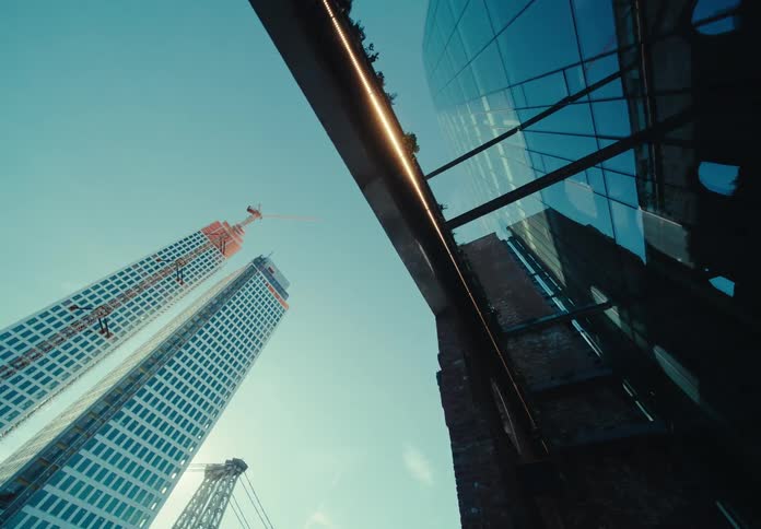 Landscape of two high rise buildings near a suspension bridge