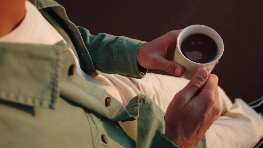 A man holding a cup of coffee