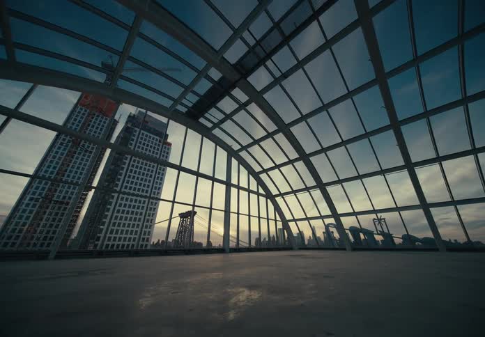A view of the city is shown through a large glass dome