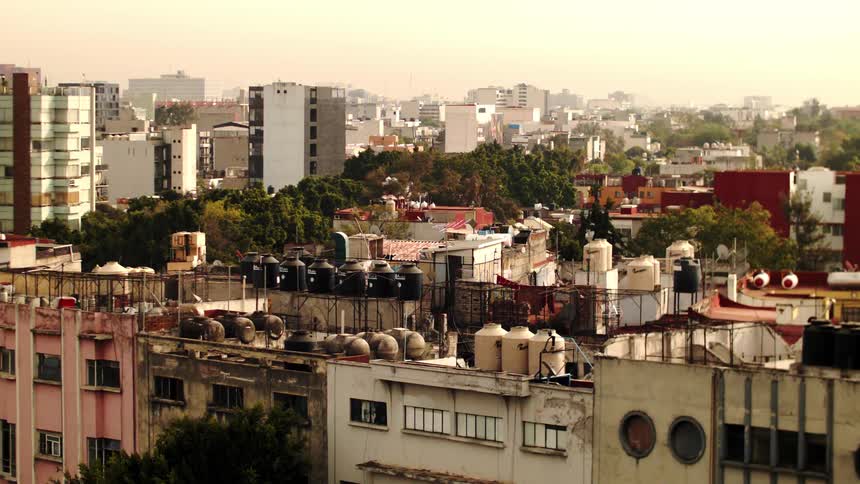 Panorama of a city with buildings and trees in a morning sky