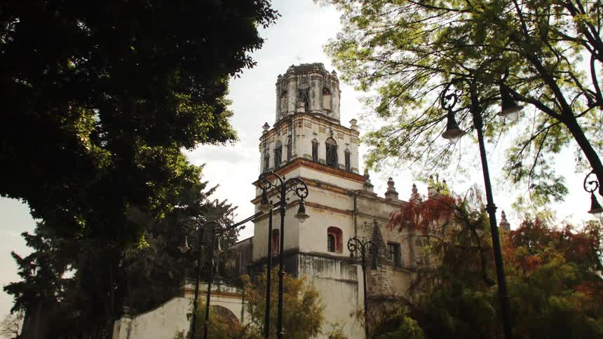 Old building amidst trees on a morning