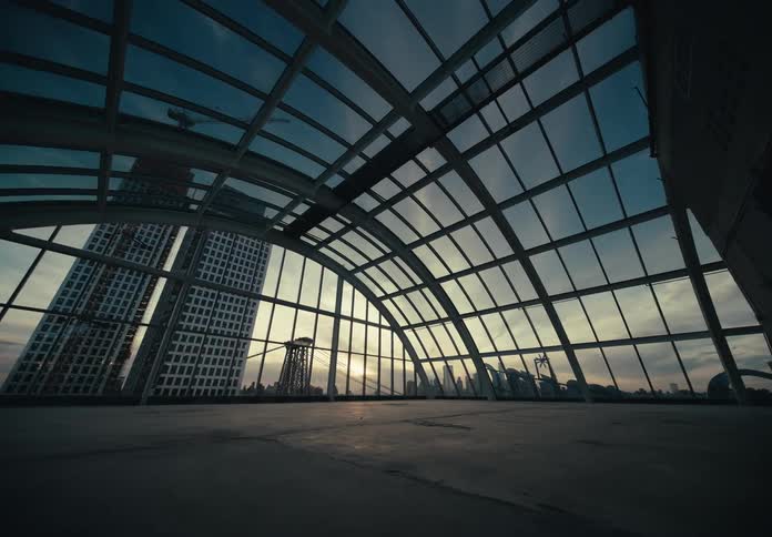 View from the terrace of a fully mirrored metropolis under a morning sky