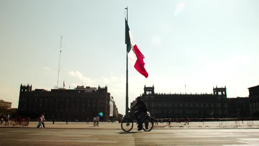The mexican flag flaps in the city center