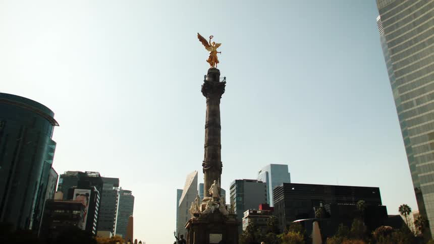 A truck transports a statue through the city