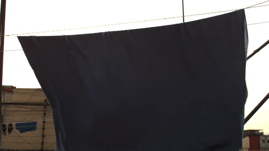 A blanket dries in the wind outdoors
