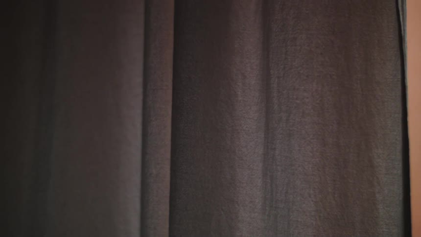 A blue curtain is shown moving slightly