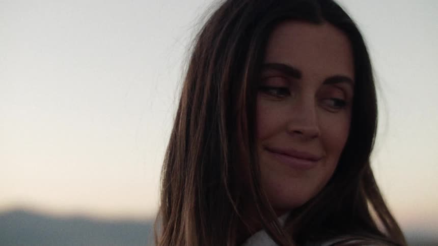 A womans face looking down and then looking to the right