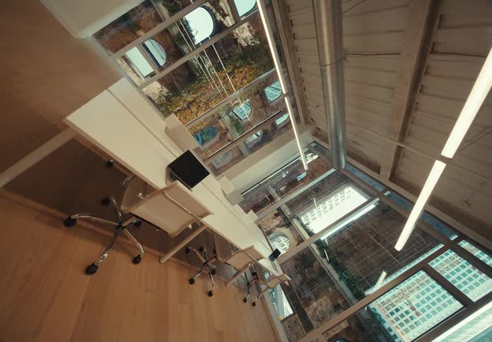 Interior design of an office room with a table chairs lighting in a building