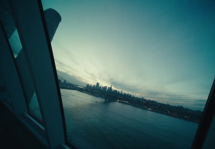 The sun is rising on the city across the river