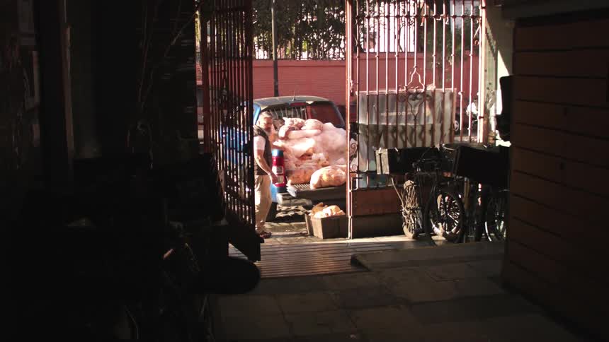 A man stands near his full pickup truck