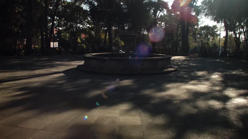 A fountain sits in the middle of a small plaza