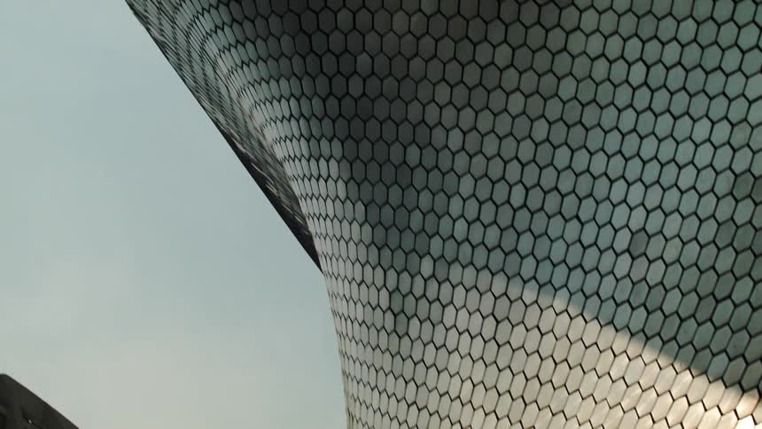 A modern building with hexagonal tiles reflecting the sun